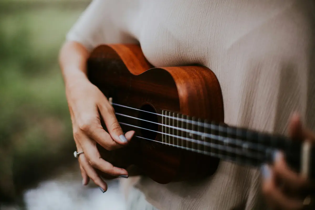 A woman playing a ukulele